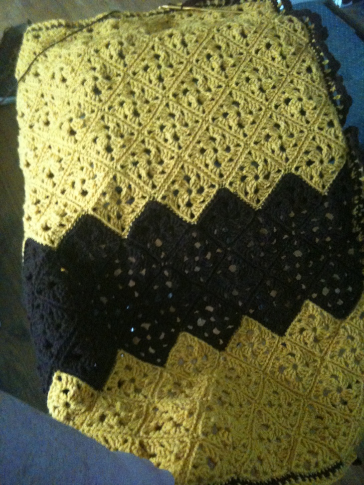 The Charllie Brown afghan is almost done! If you want to know how badly my iPhone has guessed at the colors, it is actually gold and brown, not light yellow. Anyway, I wish I'd made it a hair wider and I'll do the partial squares differently the next time I try an afghan like this, but all in all, I really love it.