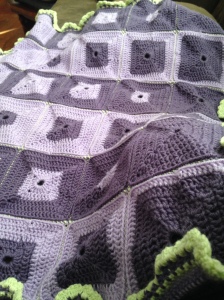 The purple afghan from the front, with green border.